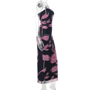 Side view detail of a floral print tube maxi dress with pink blossoms on dark fabric