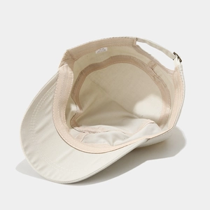 Interior view of beige cotton flat top military cap showing twill texture and stitching