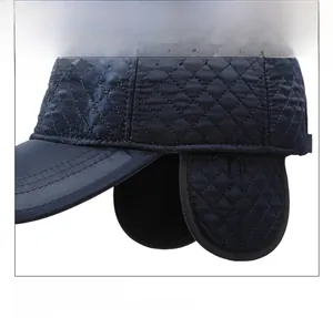Detail view of navy blue winter earflap hat with quilted rhombic texture and warm lining