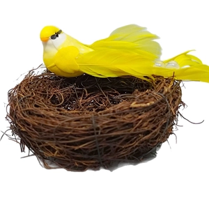 Artificial rattan bird nest with a yellow feather bird for Easter decorative ornaments