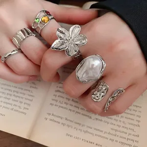 Retro 6-piece silver flower ring set with pearls and gemstones on model hand