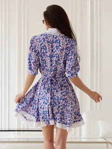 Floral short sleeve dress back view with a bow tie and white ruffled hem details