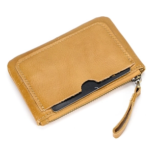 Detail of vintage brown leather coin purse showing zipper closure and card slot