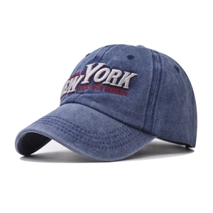 Vintage washed blue cotton baseball cap with 3D white New York embroidery on white background