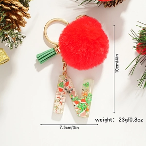 Detailed view of Christmas resin letter N keychain with red pompom and green tassel