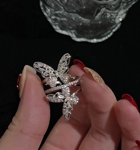 Close-up of elegant silver butterfly ring with cubic zirconia stones on hand