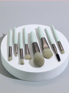 8-piece mini makeup brush set with mint green handles and soft bristles for flawless look.