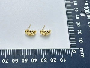 Macro shot of gold C-shape twisted earrings showing 15mm size measurement on scale