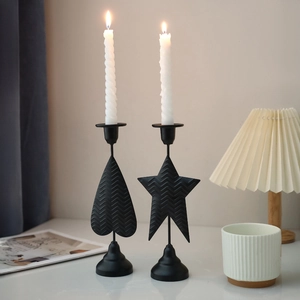 Nordic black metal lantern candle holders with heart and star shapes in a cozy interior