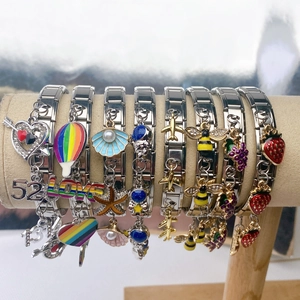 Italian style stainless steel modular charm bracelet with colorful enamel pendants on display