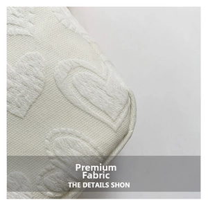 Detail of premium white jacquard fabric with elegant heart patterns on a stylish bag