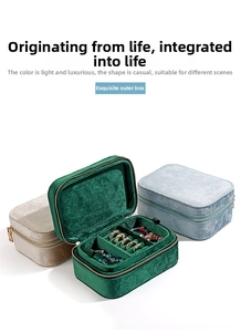 Detail view of velvet jewelry boxes in green, blue, and gold with zip closure