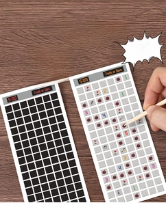 Macro view of Minesweeper scratch card game with wooden stylus on wooden desk