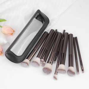 11-piece makeup brush set with wooden handles and storage bag on white fabric background