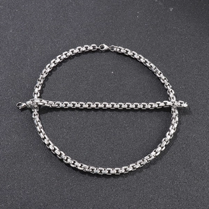 Macro view of polished silver square pearl chain links in durable titanium steel