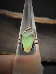 Detailed macro view of a vintage copper ring with an irregular green natural stone