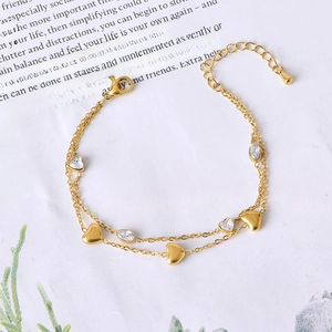 Double-layered gold chain bracelet with heart charm and white marquise zircon stones