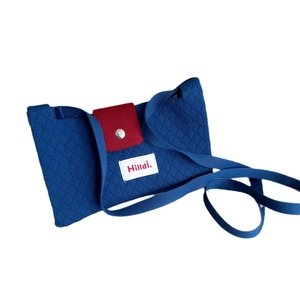 Blue knitted crossbody phone bag with red magnetic buckle and Hilldi label detail