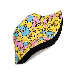 Detailed view of colorful cartoon duck patterns on a reversible cotton bucket hat
