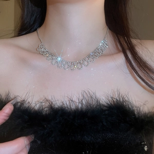 Close-up of sparkling rhinestone bow necklace on model showing elegant luxury design