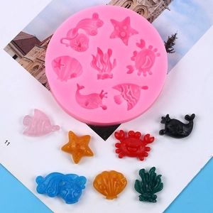 Detail view of pink silicone mold with 8 marine shapes like seahorse, starfish and shells