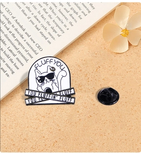 Detail of cute enamel cat pin with sunglasses and humorous text on an aesthetic background