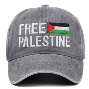 Macro shot of embroidered FREE PALESTINE text and flag on grey washed cotton baseball cap