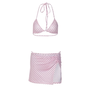 Detail of pink polka dot bikini set featuring halter top and side-slit mini skirt
