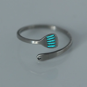 Detailed macro shot of an adjustable silver stainless steel ring with turquoise enamel stripes
