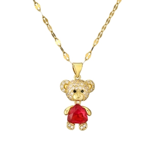 Golden bear pendant necklace with a red heart-shaped gemstone and white cubic zirconia