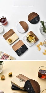 Detailed close-up of marble and acacia wood coasters in round and square shapes