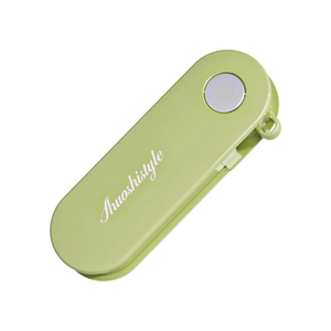 Foldable stainless steel vegetable peeler with olive green handle on white background