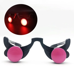 Detail of black LED goggles with pink lenses showing glowing red light for Halloween party