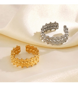Detailed macro of gold and silver irregular open rings with embossed dot texture