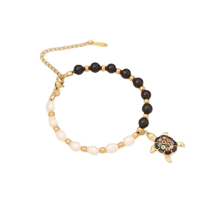 Beaded black onyx and pearl bracelet with colorful gemstone sea turtle charm