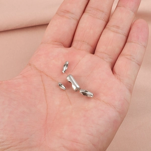 Polished silver stainless steel ball chain connectors held in hand for size visualization