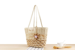 Close-up of bohemian hand-woven tote bag with intricate patterns and flower charm