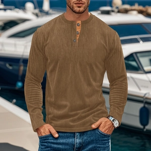 Detail of men's brown corduroy Henley shirt featuring buttoned neckline and textured fabric
