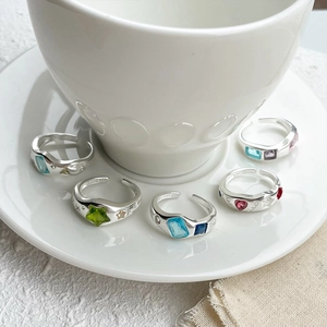 Close-up of S925 sterling silver rings with colorful heart, star and square gemstones