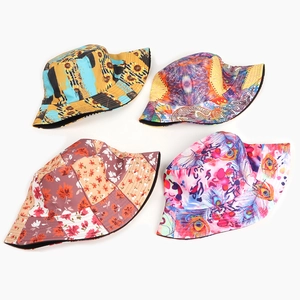 Reversible bucket hats in sunflower, abstract, and floral prints on cotton canvas
