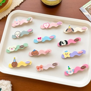 Close-up of cute cartoon animal hair clips in pastel colors with engraved labels