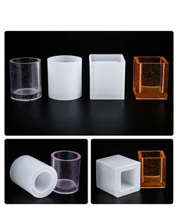 Macro detail of square and cylindrical silicone molds with finished DIY resin pen holders