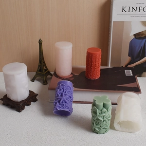 Cylindrical sunflower silicone mold and handmade candles with embossed floral textures