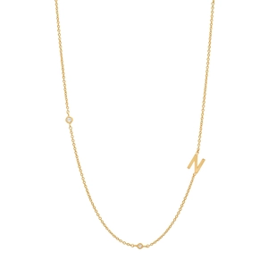 Macro shot of gold S925 silver necklace featuring a letter N pendant and small gems