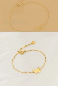 Detail of gold butterfly bracelet showing adjustable chain and lobster clasp