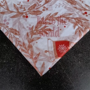 Detail of Christmas tissue paper with gold leaf pattern and Joy to the World text
