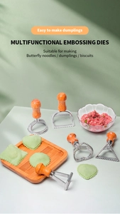 Detail of metal dumpling mold set with wooden handles and heart shaped ravioli cutters