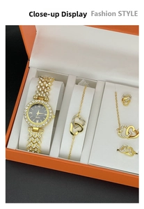 Detail of elegant gold women's watch set with crystal-inlaid bezel and jewelry in box