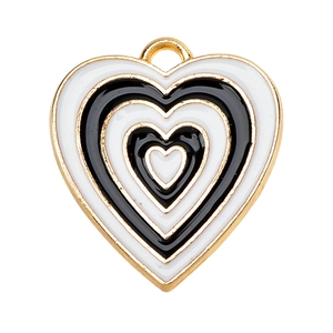 Detail of layered black and white heart enamel pendant with gold metal edges
