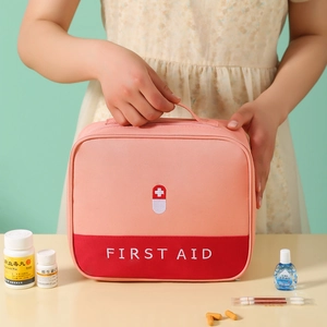 Pink first aid medical storage bag with top handle and white cross logo for home travel